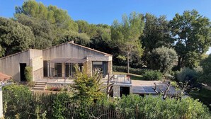 A modern house with a stone facade, large windows, and a patio area. - Small house near Uzes and the Pont du Gard, ideal for 2 or 4 people (Saint-Maximin)