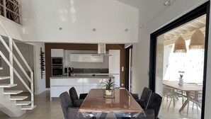 A modern kitchen with white cabinets, a stainless steel range hood, and a built-in oven. - Private cocoon & swimming pool Absolute calm (Rognonas)