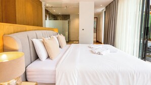 A hotel room with a large bed, a headboard, and a bedside lamp. - Villa Luma Botanica | Private Pool Villa Near Bang Tao Beach (Tambon Choeng Thale)