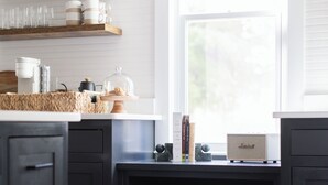 A kitchen with wooden shelves, a coffee machine, and storage bins. - Near Benning, Steps to Riverwalk/Bibb Mill, 2 Kings, Queen Sofa Bed, Sleeps 6 (Columbus)
