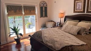 A bedroom with a large bed, a potted plant, a nightstand, and a lamp. - RuneStone Ranch: on Lake Cumberland, Upper Level, Russell Springs (Russell Springs)