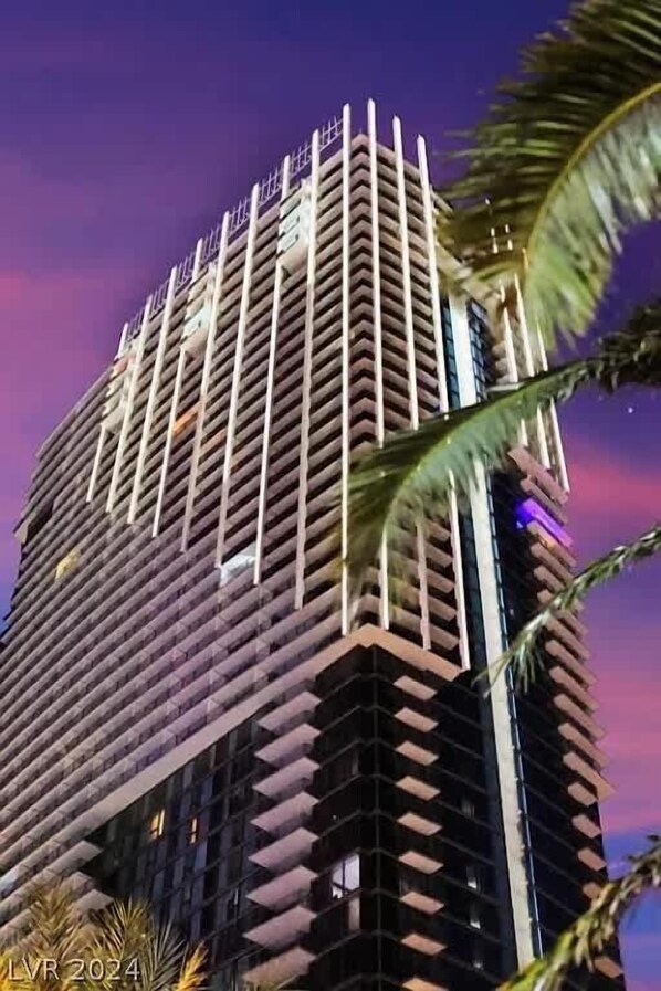 A tall, modern building with a unique angular design and balconies. - Incredible Views 51st Floor High-Rise Studio -Balcony (Las Vegas)