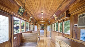 A wooden interior with a bench, windows, and a bed. - Huge 5 Bed Party House: Pool/Renovated Tram/Bar/Games Room/Family Stay (Clyde)