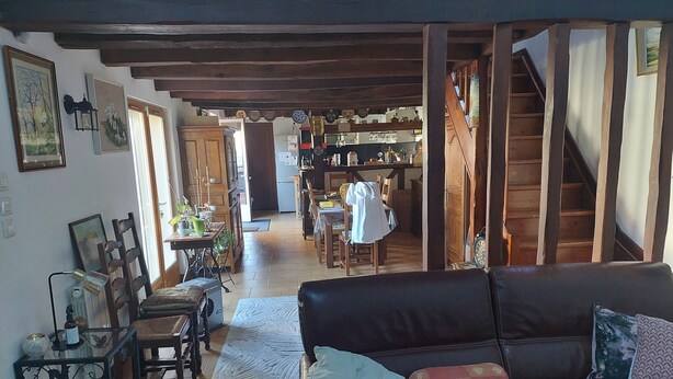 A cozy living room with a leather sofa, a dining area, and a kitchen in the background. - House sleeps 6, parking, daily rental, 10 mmde rouen, 1 hde paris (Criquebeuf-sur-Seine)