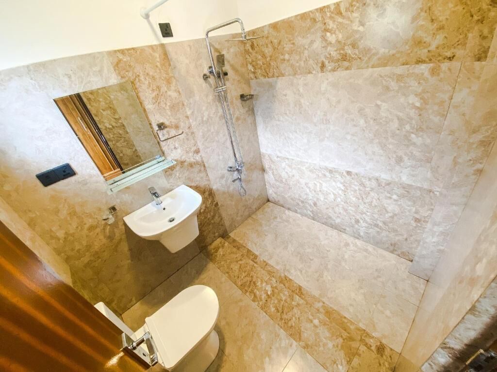 A bathroom with a shower, sink, and toilet.