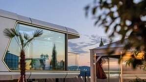 A modern building with large glass windows, a flat roof, and a view of the landscape. - Gyeongju Holiday Space Pension (Gyeongju)