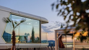 A modern building with large glass windows, a flat roof, and a view of the landscape. - Gyeongju Holiday Space Pension (Gyeongju)