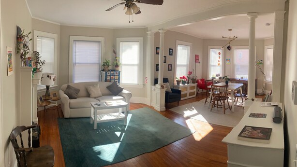 A spacious living room with a sofa, coffee table, and dining area. - The perfect blend of space and comfort in Providence, RI. (Providence)