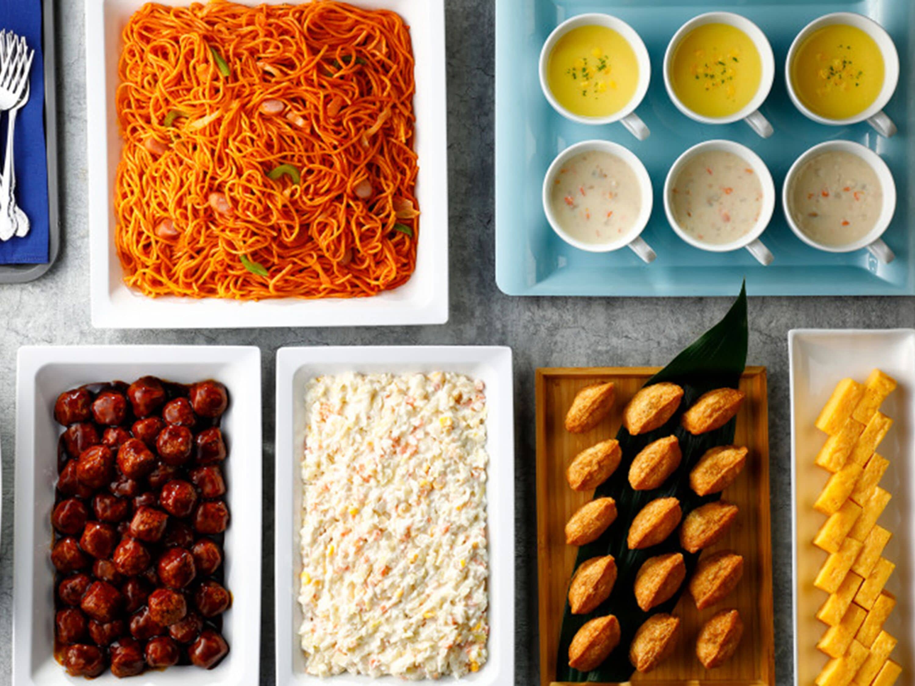 A variety of dishes including noodles, soup, and a salad.