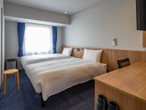 A hotel room with two beds, a desk, a chair, and a TV. - Toyoko Inn Kure-eki (Kure)
