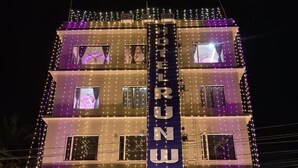 A multi-story hotel with a prominent vertical sign displaying the name 'HOTEL RUNWAY'. - Hotel Runway (Barakpur)