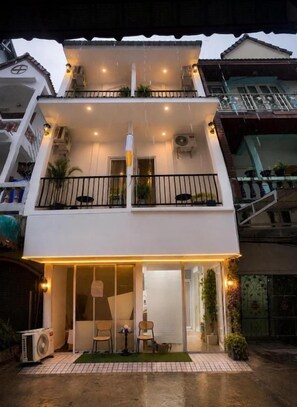 A two-story building with a balcony, a covered entrance, and a small outdoor seating area. - Patong Beach Verve (Patong)
