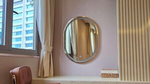A room with a window, a mirror, a chair, and a small table. - li qiong hotel (Ho Chi Minh City)