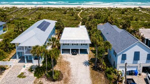 A coastal property with two main buildings, a paved driveway, and a beach view. - Oceanfront Home w/ Pool + Private Beach Access (St. Augustine)