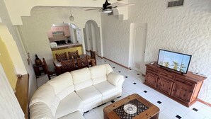 A living room with a sectional sofa, a coffee table, and a TV stand. - Beautiful & Spacious 2 bed 2 bath Condo in Casa Bonita.  Ixtapa ,Zihuatanejo (Ixtapa Zihuatanejo)