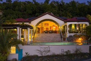 A two-story house with a swimming pool, a covered patio, and solar panels. - Arc Du Soleil- Ultimate Island Living, Refreshing Salt Water Pool, Stunning Views! (Cruz Bay)