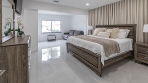 Een moderne slaapkamer met een houten bed, een bureau en een stoel.