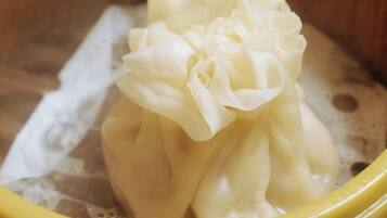 A yellow bowl containing a white, fluffy substance, possibly a food item, in a liquid environment.