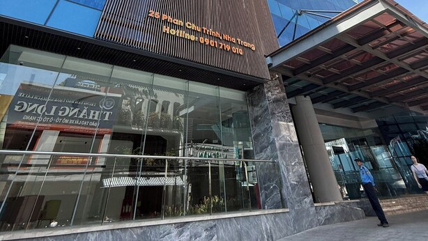 A modern hotel with a prominent sign for 'Marina Suites' and a contact number. - Center-Beachfront Breeze Apt–2BR-3 beds- Fast WiFi (Nha Trang)