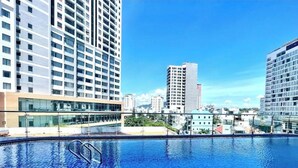 A rooftop swimming pool with a tiled design, surrounded by high-rise buildings. - Center-Beachfront Breeze Apt–2BR-3 beds- Fast WiFi (Nha Trang)