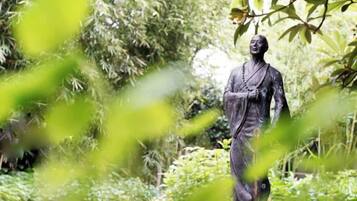 A statue in a garden setting.