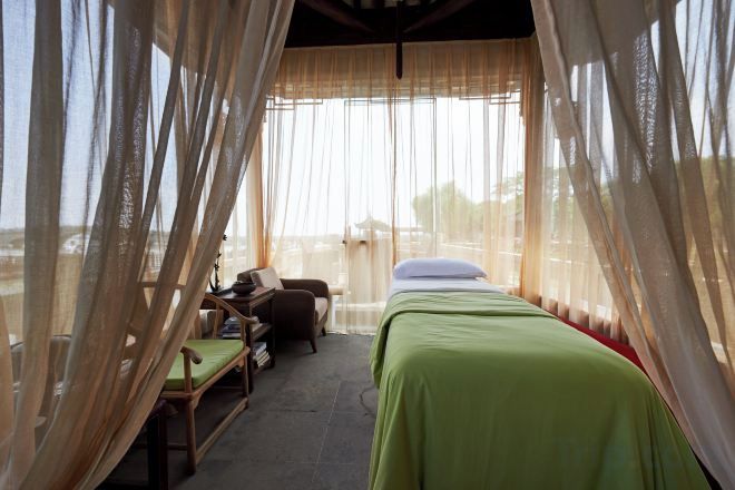 A room with a bed, a chair, and a desk.