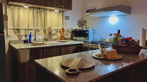 A kitchen with a gas stove, a toaster, and a sink. - Rooftop Bliss Cozy 2-bedroom condo in soothing Punta Cana with private rooftop (Punta Cana)