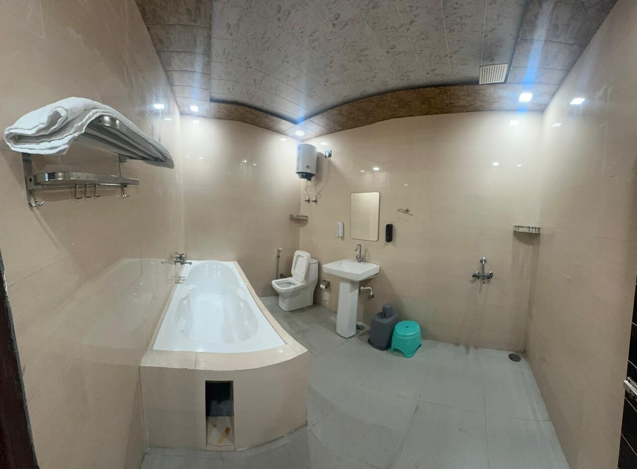 A modern bathroom with a bathtub, toilet, sink, and shower.