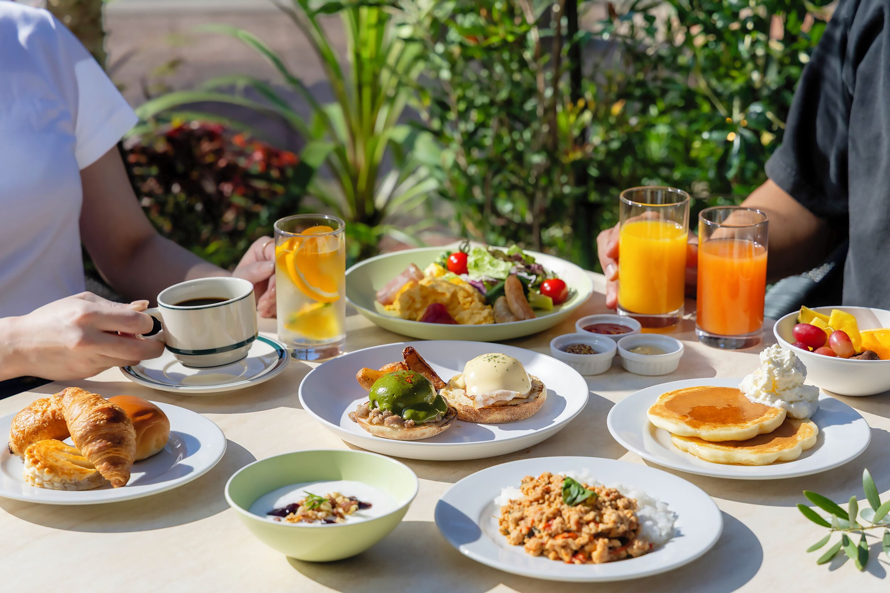 A breakfast table with various dishes, including eggs, toast, and fruit.