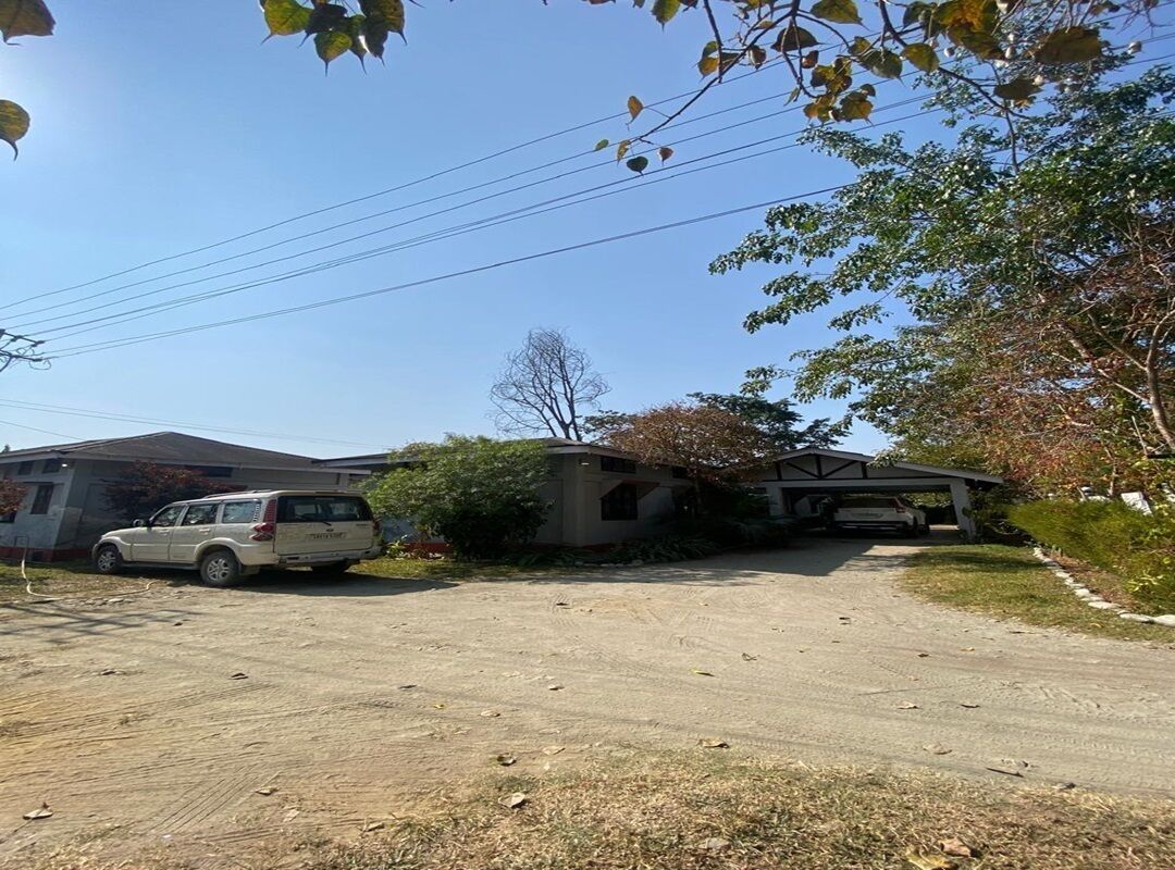 A residential driveway with a parked SUV, a house with a garage, and a covered porch.