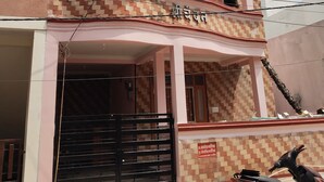 A multi-story building with a tiled facade and a gated entrance.