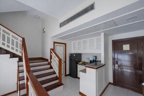 A kitchen with a refrigerator, a coffee maker, and a sink. - Condo 2 BR in Laguna (Lake View) (Phuket)