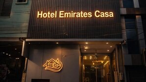 A modern building with a sign for 'Hotel Emirates Casa' and a neon logo. - Hotel Emirates Case (Raipur)
