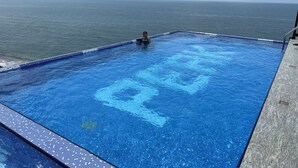 A rectangular infinity pool with a clear view of the ocean.