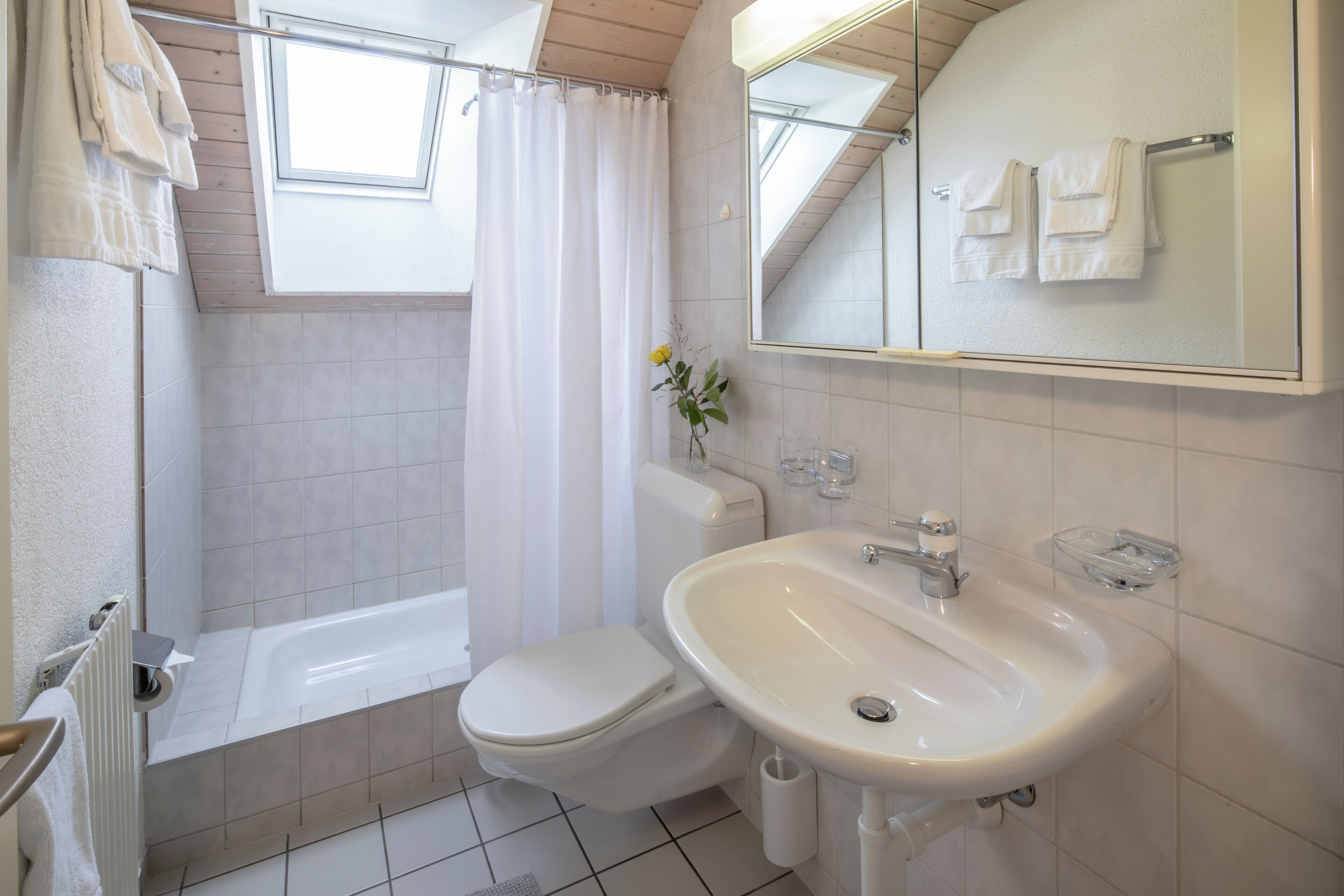 Un baño con bañera, inodoro y lavamanos.