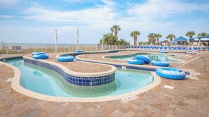 A pool area with blue water, lounge chairs, and a sign indicating shallow water no diving allowed. - Cozy 2-bedroom condo on the 10th Floor, located in fantastic North Myrtle Beach (North Myrtle Beach)