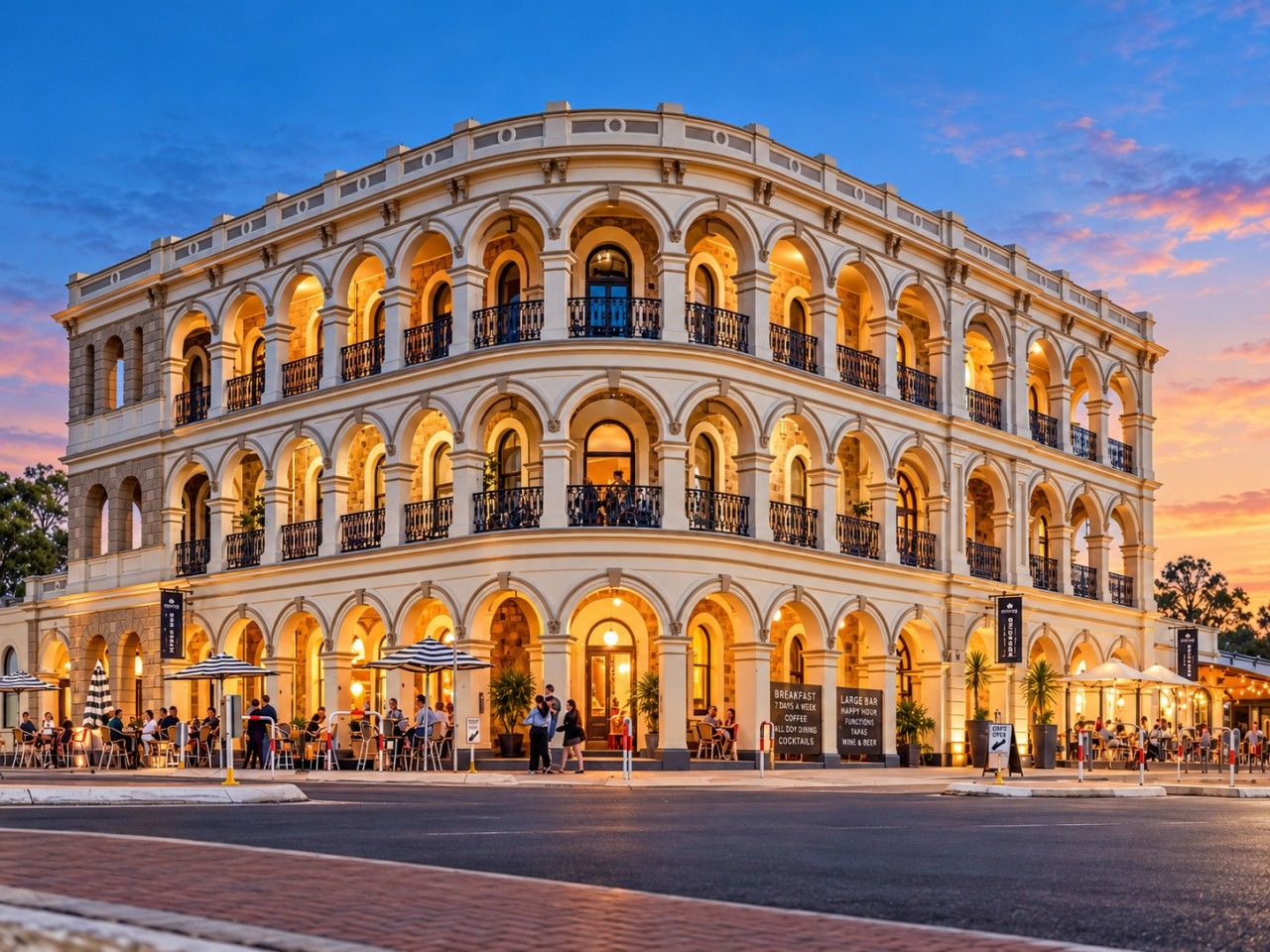 A multi-story building with a classical architectural style, featuring arched windows and balconies.