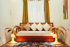 A bed with a wooden frame, white bedding, and decorative lamps. - Matahom Forest House by Araw Residences (Mambajao)