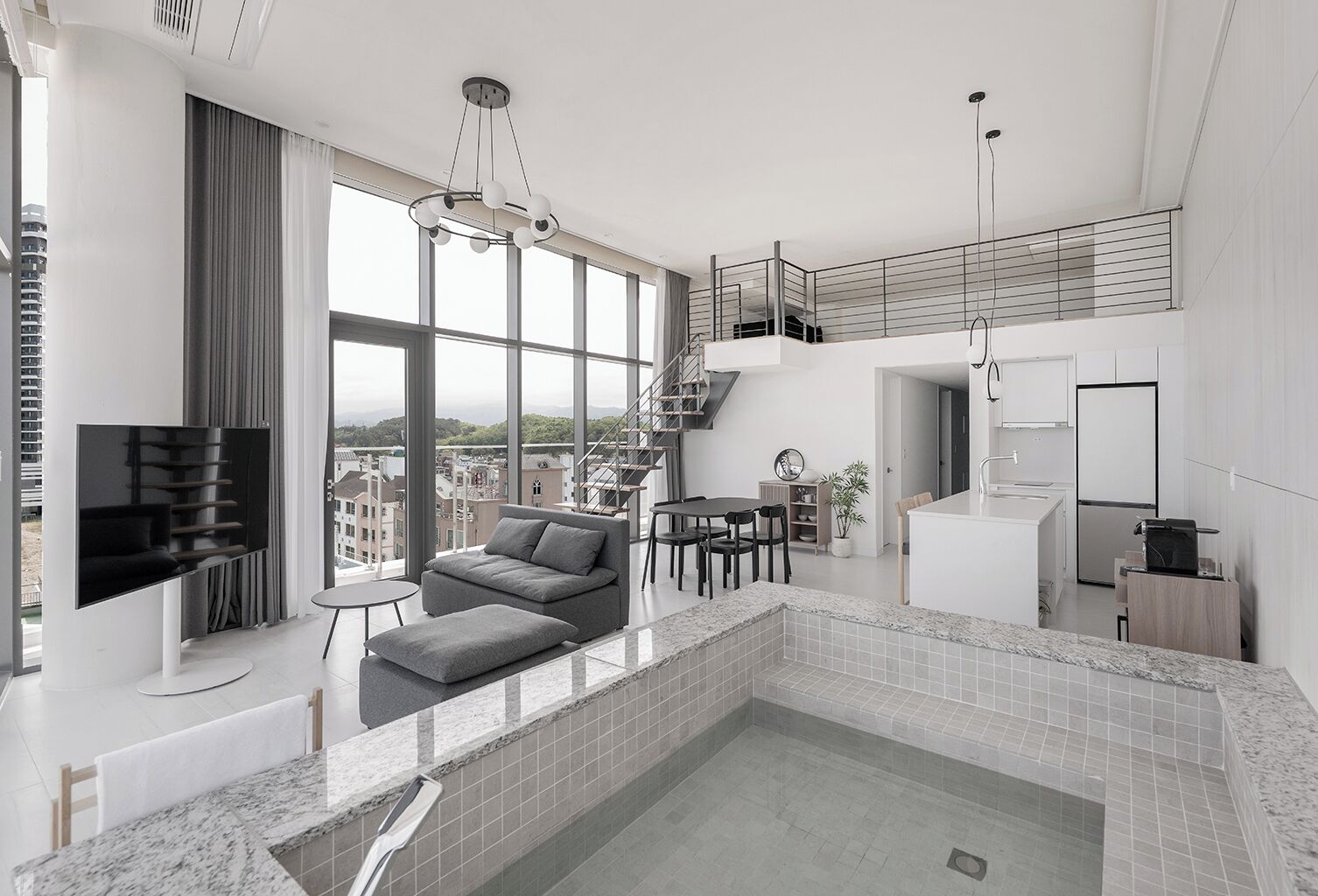 A modern interior with a living area, kitchen, and a small indoor pool.