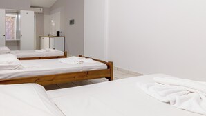 A hotel room with two single beds, a wardrobe, and a mirror. - Apollo Hotel (Zakynthos)