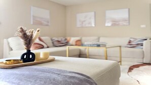 A living room with a sofa, a coffee table, and artwork on the walls. - Pearly EuroPoint (Saint-Louis)