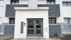 A modern building with a central entrance, large windows, and a flat roof. - Atlantic Central Apartment (Ponta Delgada)