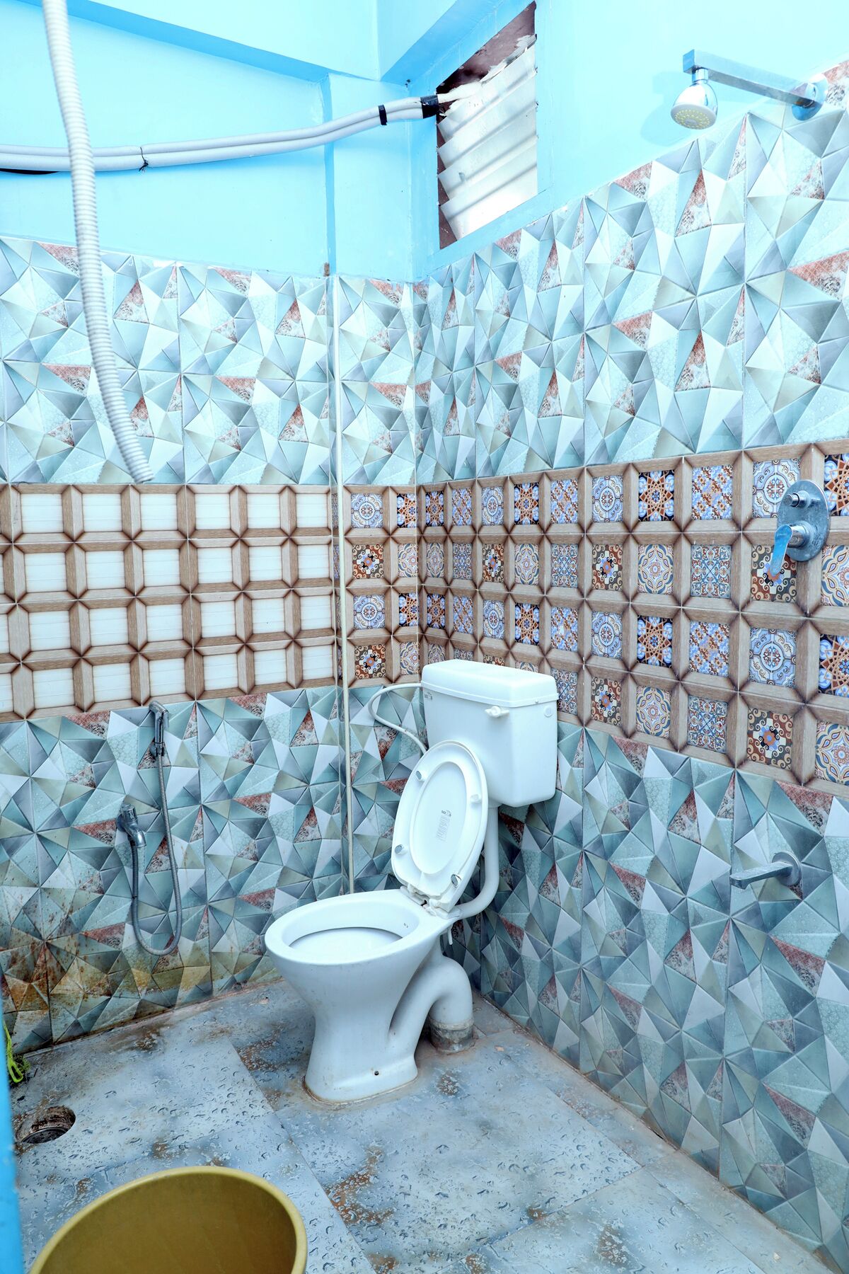 A bathroom with a toilet, shower, and tiled walls.