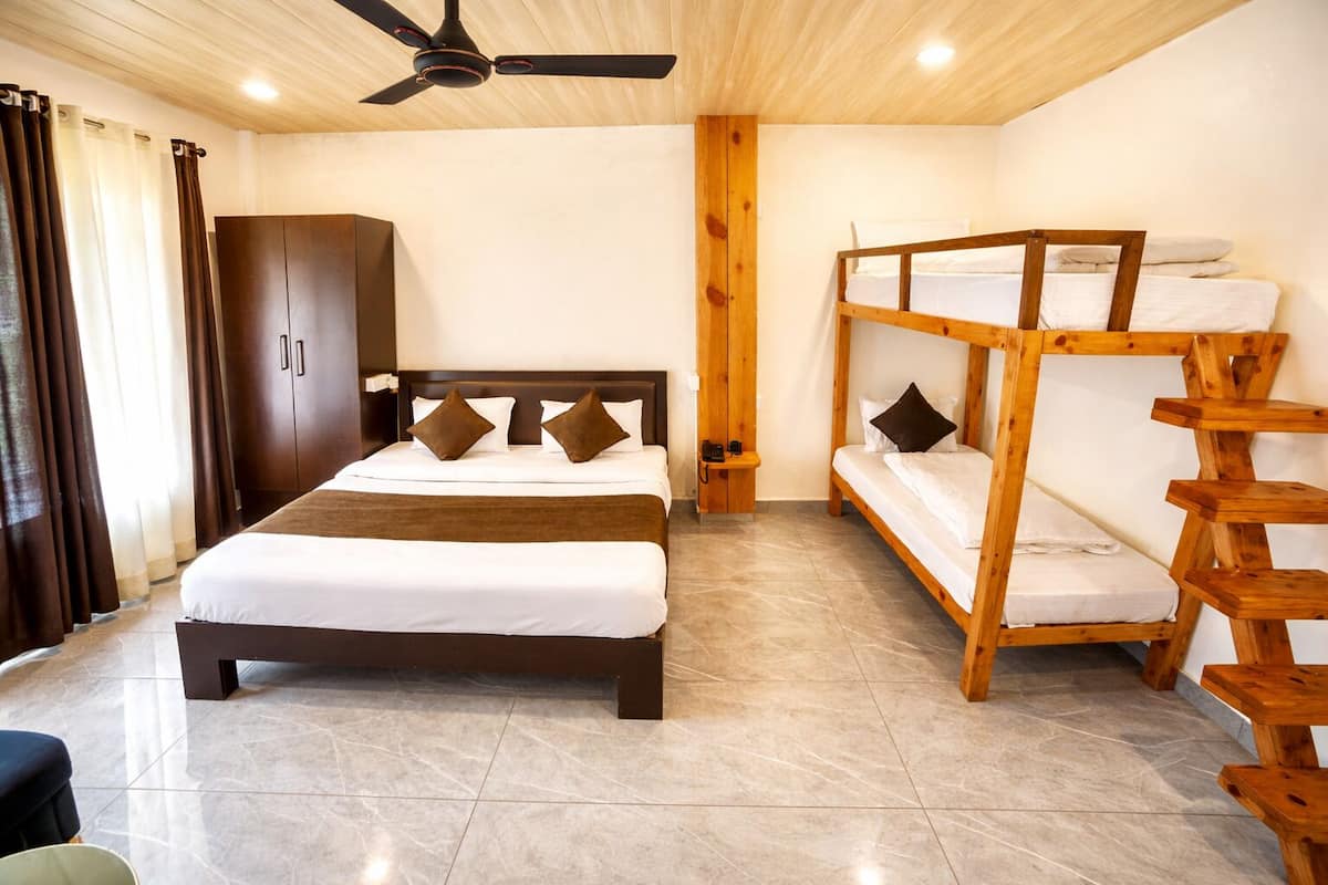 A room with a bed, a wardrobe, a bunk bed, and a ceiling fan.
