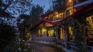 A two-story house with a balcony, surrounded by greenery. - Alaya Stays The Hive Cottage (Nainital)