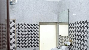 A bathroom with a toilet, sink, and shower. - Hotel Tavooza Formely Sumangal (Gwalior)