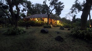A secluded house surrounded by large trees and rocks in a natural setting. - Babakan Hill Villas (Karangasem)