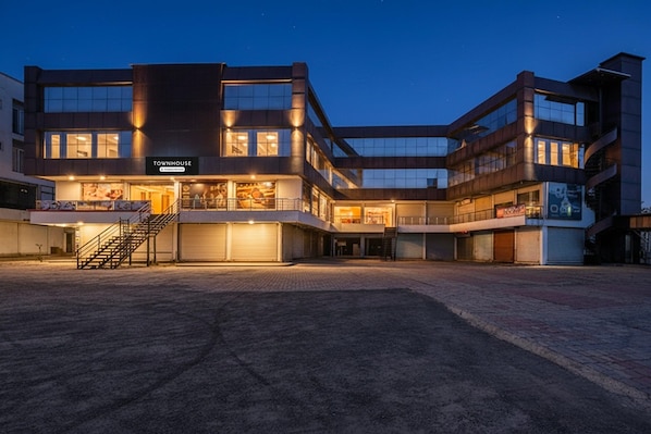 A multi-story building with a sign reading 'Townhouse.'