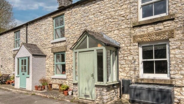 A stone building with a green door, windows, and a chimney. - 2, THE LODGE, TIDESWELL (Tideswell)