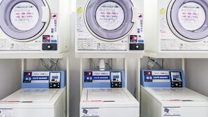 Three identical machines labeled 'CO/N DRYER 45' with control panels and a circular drum. - Hotel Livemax Budget Nagoya Taiko Doriguchi (Nagoya)